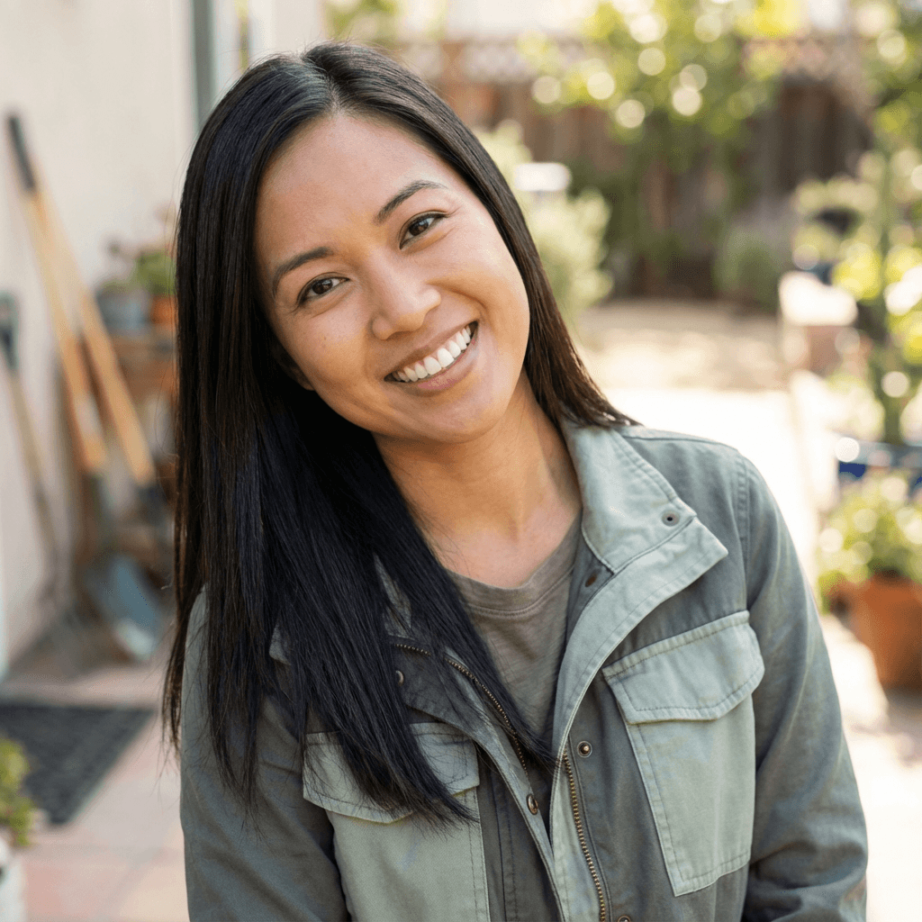 Woman with a warm expression in a sunlit residential room